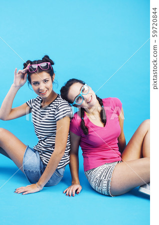 lifestyle people concept: two pretty young school teenage girls having fun happy smiling on blue 59720844