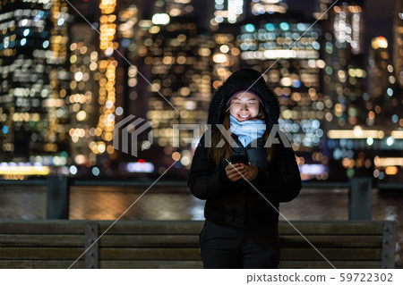 Asian woman in Winter suit using smart mobile phone with smile action over the photo blurred bokeh of New york Cityscape beside the east river background, USA downtown, career concept Asian woman in Winter suit using smart mobile phone with smile action over the photo blurred bokeh of New york Cityscape beside the east river background, USA downtown, career concept 59722302