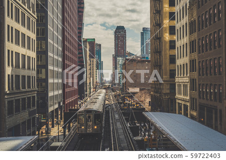 Elevated Train Tracks are running above the Railroad tracks between the building at the Loop line at Chicago, Illinois, USA 59722403