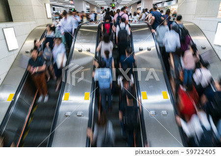 Crowd of Pedestrians Unrecognizable walking in escalator in rush hour morning before working time in subway transportation hub, Hong Kong, Central District, fast moving and business people concept 59722405