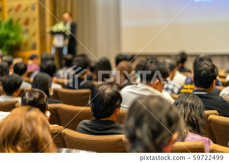 Back side of audience listening the Speaker with podium on the stage in the conference hall, business and education concept 59722499