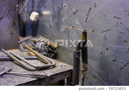 Welder working welding machine. Welding of rebar and reinforcing mesh. for concrete reinforcement Welder working welding machine. Welding of rebar and reinforcing mesh. for concrete reinforcement 59723653