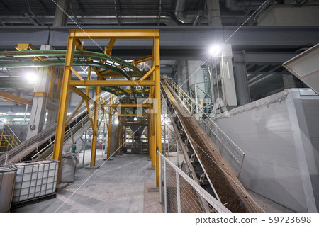 Large industrial mixer, for mixing ingredients into liquid cement.. Workers in the workshop of the Large industrial mixer, for mixing ingredients into liquid cement.. Workers in the workshop of the 59723698