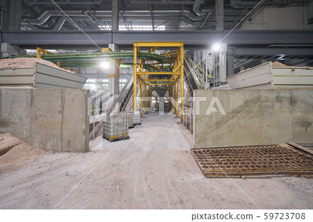 Large industrial mixer, for mixing ingredients into liquid cement.. Workers in the workshop of the Large industrial mixer, for mixing ingredients into liquid cement.. Workers in the workshop of the 59723708