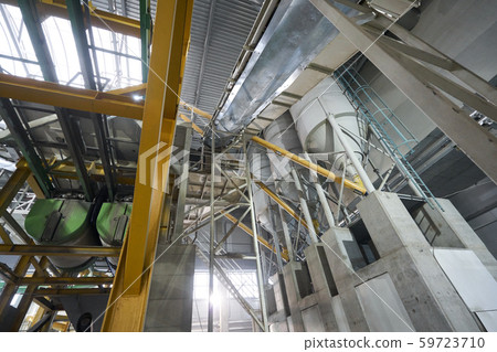 Large industrial mixer, for mixing ingredients into liquid cement.. Workers in the workshop of the Large industrial mixer, for mixing ingredients into liquid cement.. Workers in the workshop of the 59723710