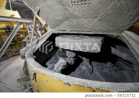 Large industrial mixer, for mixing ingredients into liquid cement.. Workers in the workshop of the Large industrial mixer, for mixing ingredients into liquid cement.. Workers in the workshop of the 59723732