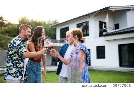 Portrait of people with wine outdoors on family garden barbecue. Portrait of people with wine outdoors on family garden barbecue. 59727908