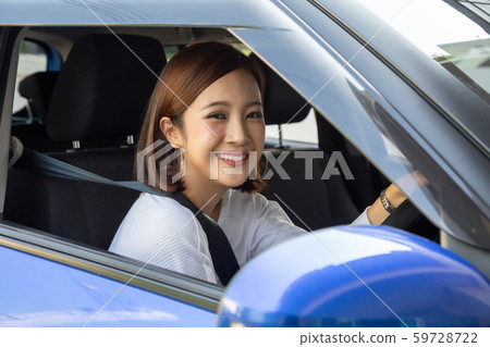 Asian women driving a car and smile happily  59728722