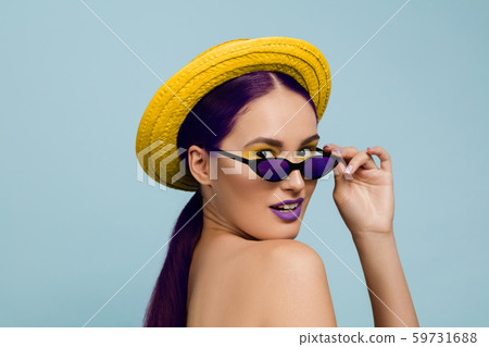 Portrait of beautiful young woman with bright make-up isolated on blue studio background 59731688