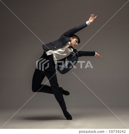 Man in casual office style clothes jumping isolated on studio background Man in casual office style clothes jumping isolated on studio background 59739242