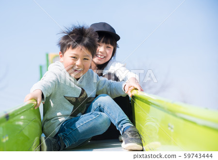 Children playing on the slide 59743444