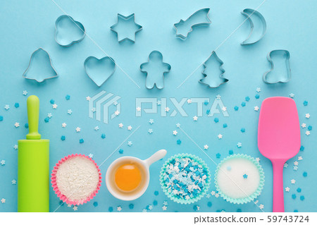 ingredients for baking and kitchen tools with cookie cutter on blue background, flat lay ingredients for baking and kitchen tools with cookie cutter on blue background, flat lay 59743724