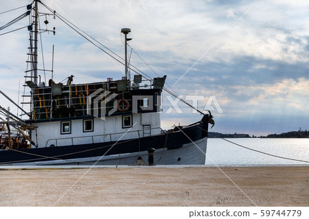 Old fishing boat anchored in the port 59744779