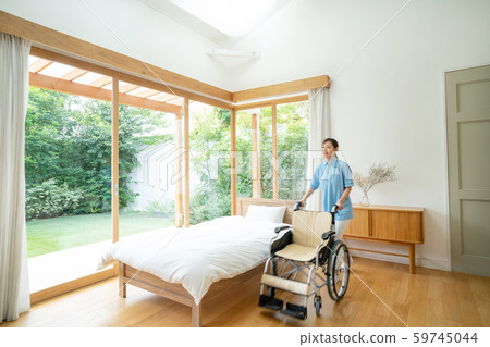 Caregiver care facility wheelchair hospital room medical image 59745044