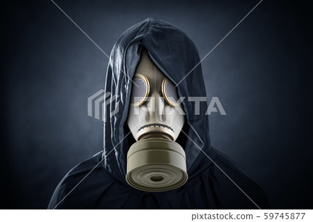 Man in a gas mask and hooded cloak. Environment pollution. Man in a gas mask and hooded cloak. Environment pollution. 59745877