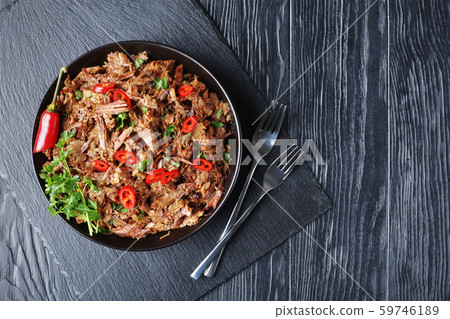 spicy slow-cooked pulled beef with chili pepper 59746189