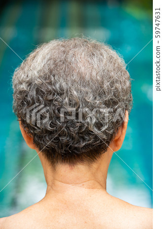 Senior woman's grey curly hair, Back head, Close up, Body concept 59747631