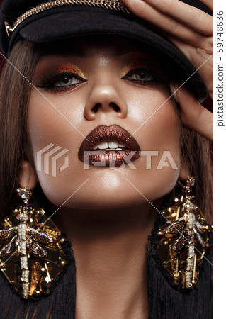 Beautiful brunette girl with curls, bright make-up and designer accessories. Beauty face. Beautiful brunette girl with curls, bright make-up and designer accessories. Beauty face. 59748636