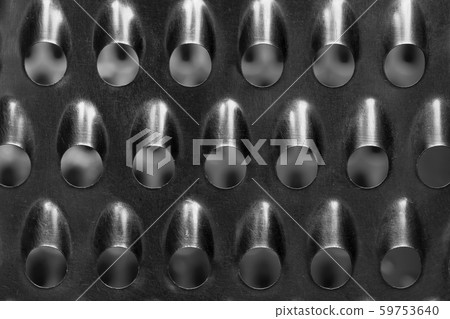 The texture of the surface of the kitchen grater. 59753640