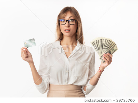Surprised Woman Standing Holding Money And Credit Card, Studio Shot 59753700