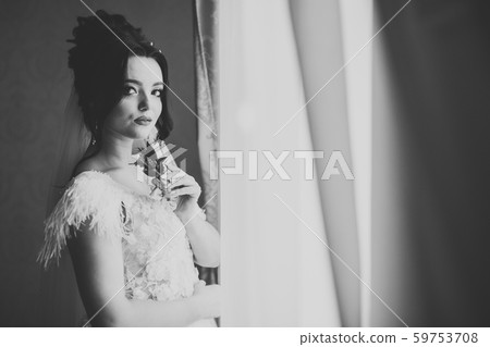 Beautiful bride wearing fashion wedding dress with feathers with luxury delight make-up and 59753708