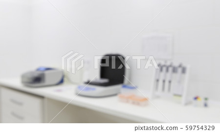 Blurred photo of medical lab equipment on table in light room Blurred photo of medical lab equipment on table in light room 59754329