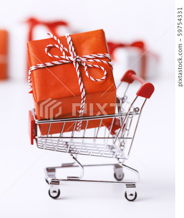 Close up of shopping cart with big Christmas present box Close up of shopping cart with big Christmas present box 59754331