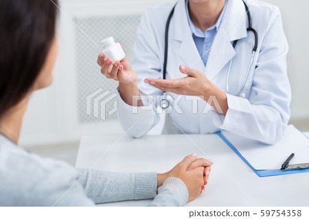 Doctor Giving Instructions On Treatment For Patient Sitting In Office Doctor Giving Instructions On Treatment For Patient Sitting In Office 59754358