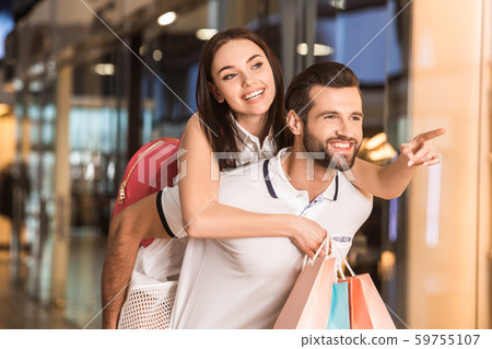 Young adult girlfriend and boyfriend having fun in stylish store Young adult girlfriend and boyfriend having fun in stylish store 59755107