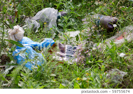 LUGANSK , UKRAINE 7 Sep - 2019 : Discarded on the roadside trash , the urban environment pollution LUGANSK , UKRAINE 7 Sep - 2019 : Discarded on the roadside trash , the urban environment pollution 59755674