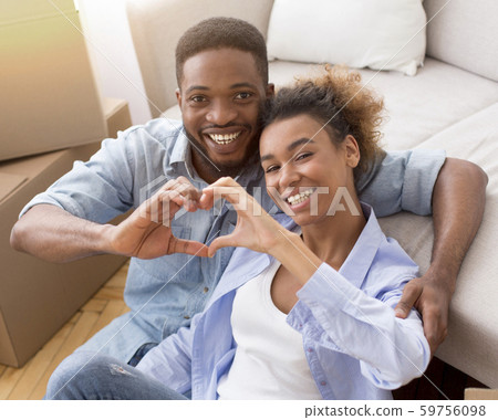 Black Couple Gesturing Heart Shape Sitting Among Moving Boxes Indoor Black Couple Gesturing Heart Shape Sitting Among Moving Boxes Indoor 59756098