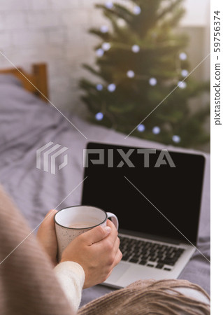 Woman with white cup and open new laptop with black blank screen Woman with white cup and open new laptop with black blank screen 59756374