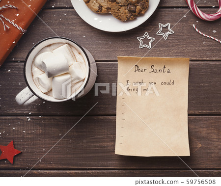 Wish list letter to Santa claus from child on wooden background Wish list letter to Santa claus from child on wooden background 59756508