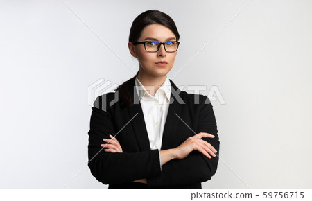 Business Girl Standing Looking At Camera Crossing Hands, Studio Shot 59756715