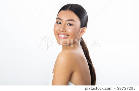 Body care. Young asian woman in bath towel smiling to camera 59757295