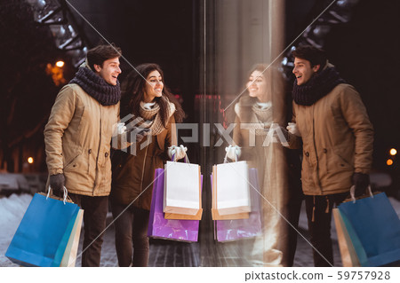 Spouses Looking At Shopwindow Shopping In Night City In Winter Spouses Looking At Shopwindow Shopping In Night City In Winter 59757928