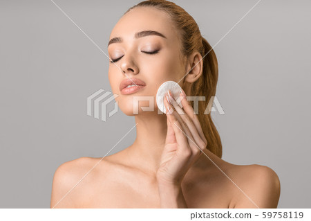 Skincare concept. Beautiful woman cleaning skin by cotton pad 59758119