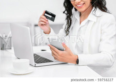 Happy woman with credit card and mobile phone Happy woman with credit card and mobile phone 59758227