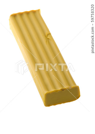 Yellow plasticine on white macro Yellow plasticine on white macro 59758320