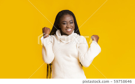 Emotional afro woman expressing happiness, clenching fists Emotional afro woman expressing happiness, clenching fists 59758646