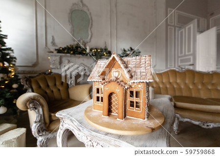 Postcard gingerbread house. Defocused lights of Christmas tree. Holiday mood. Christmas and Happy Postcard gingerbread house. Defocused lights of Christmas tree. Holiday mood. Christmas and Happy 59759868