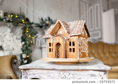 Postcard gingerbread house. Defocused lights of Christmas tree. Holiday mood. Christmas and Happy Postcard gingerbread house. Defocused lights of Christmas tree. Holiday mood. Christmas and Happy 59759872