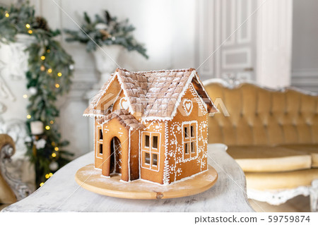 Postcard gingerbread house. Defocused lights of Christmas tree. Holiday mood. Christmas and Happy Postcard gingerbread house. Defocused lights of Christmas tree. Holiday mood. Christmas and Happy 59759874
