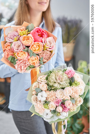 European floral shop. Two Beautiful bouquets of mixed flowers in womans hands. the work of the European floral shop. Two Beautiful bouquets of mixed flowers in womans hands. the work of the 59760006