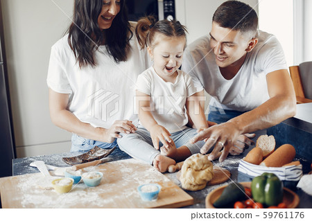Family cook the dough for cookies at the kitchen 59761176