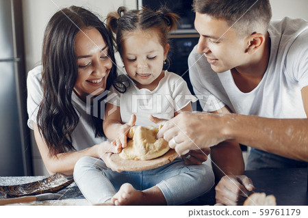 Family cook the dough for cookies at the kitchen 59761179