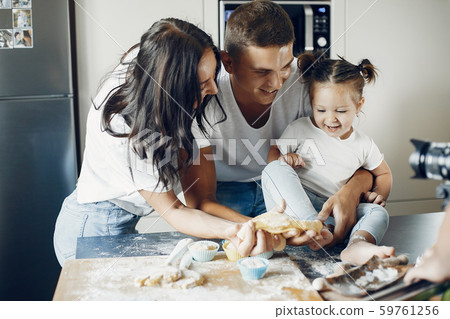 Family cook the dough for cookies at the kitchen 59761256