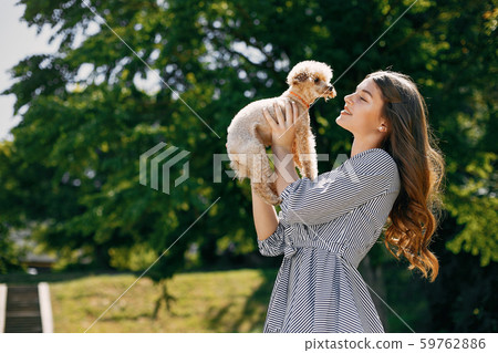 Elegant and stylish girl in a spring park Elegant and stylish girl in a spring park 59762886
