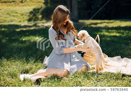 Elegant and stylish girl in a spring park Elegant and stylish girl in a spring park 59763840