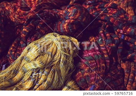 close up of red and yellow colour tie dye silk yarn for weaving close up of red and yellow colour tie dye silk yarn for weaving 59765716